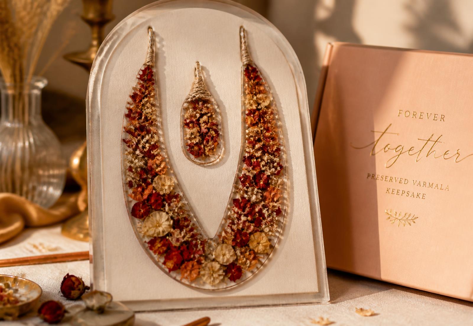 Preserved varmala keepsake set in resin, lit by warm evening light